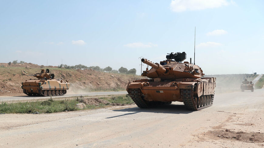 Turkish military tanks drive past the town of Ariha on the M4 highway in Syria's rebel-held northwestern Idlib province on May 7, 2020. 