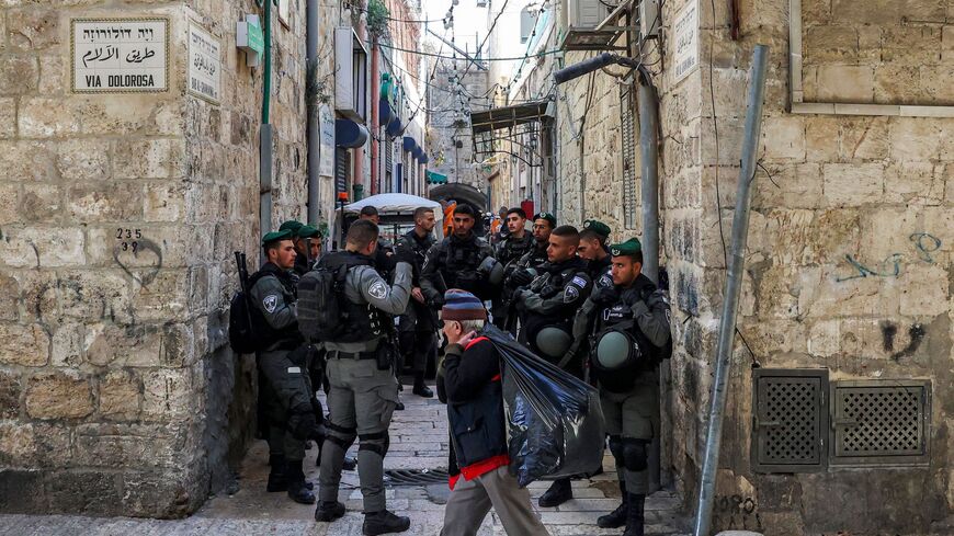 Israeli border police members gather by the Via Dolorosa in the old city of Jerusalem on March 28, 2022.