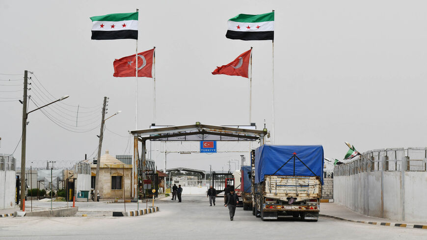 Syrians coming from Turkey go through the Bab al-Salame crossing in the border town of Azaz, to spend the last days of Ramadan and the Eid al-Fitr holiday with family in Syria, in Aleppo province, Syria, April 18, 2022.