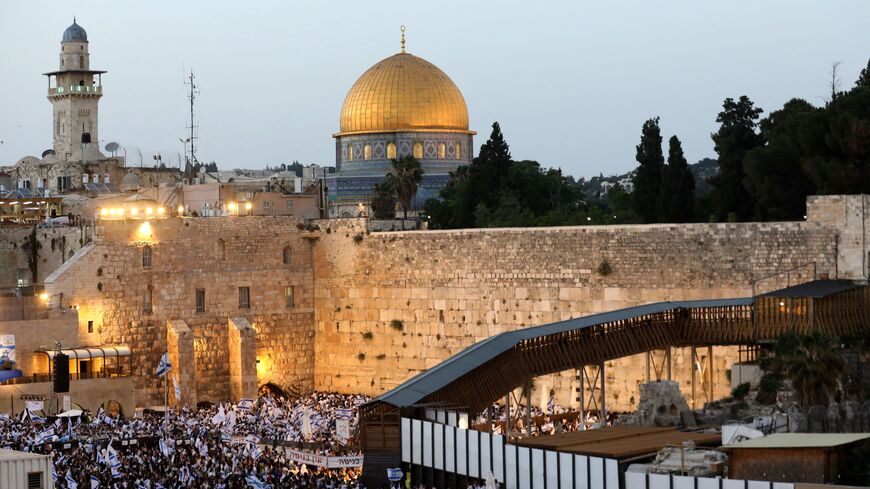 Demonstrators gather with Israeli flags at the Western Wall in the old city of Jerusalem on May 29, 2022, during the Israeli 'flags march' to mark "Jerusalem Day". 