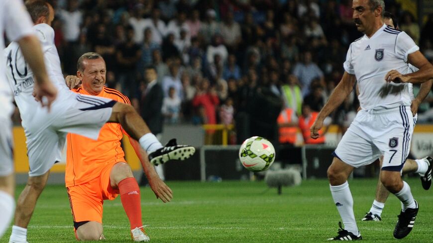 Turkish Prime Minister Recep Tayyip Erdogan (L) takes part in an exhibition football match.