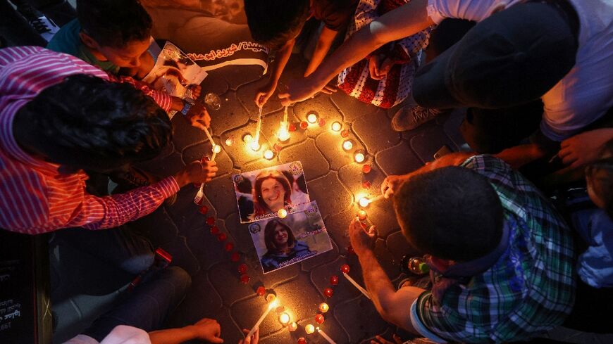 Palestinians light candles during a vigil in honour of Al-Jazeera journalist Shireen Abu Akleh in Gaza City on May 26, 2022