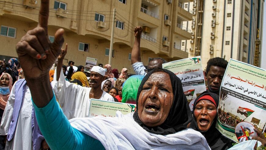 A Sudanese women protests outside the United Nations headquarters in Khartoum, calling for the UN chief in Sudan to quit