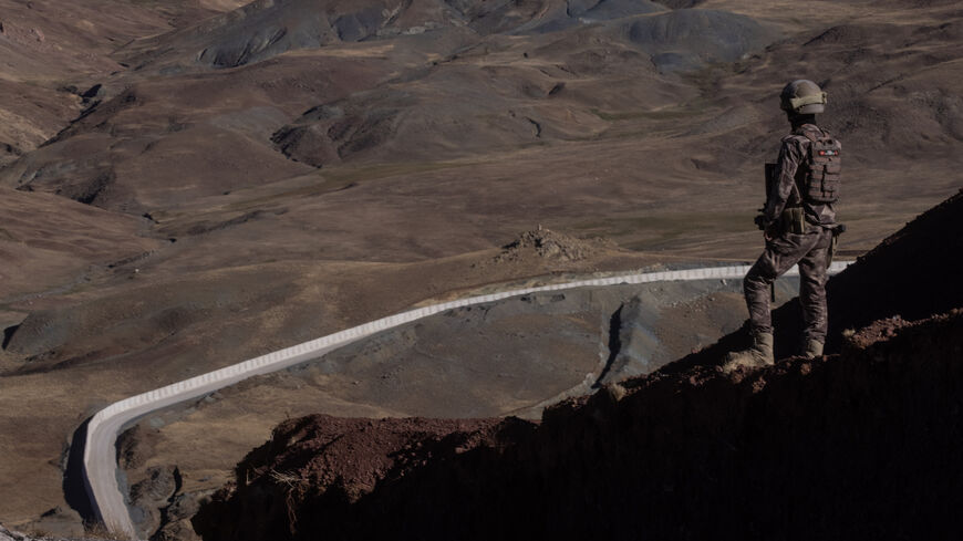 A Turkish Special Forces Police officer is seen standing watch during a press tour at a border outpost in front of a section of the new Iran - Turkey border wall on Sept. 27, 2021 in Caldiran, Turkey. 