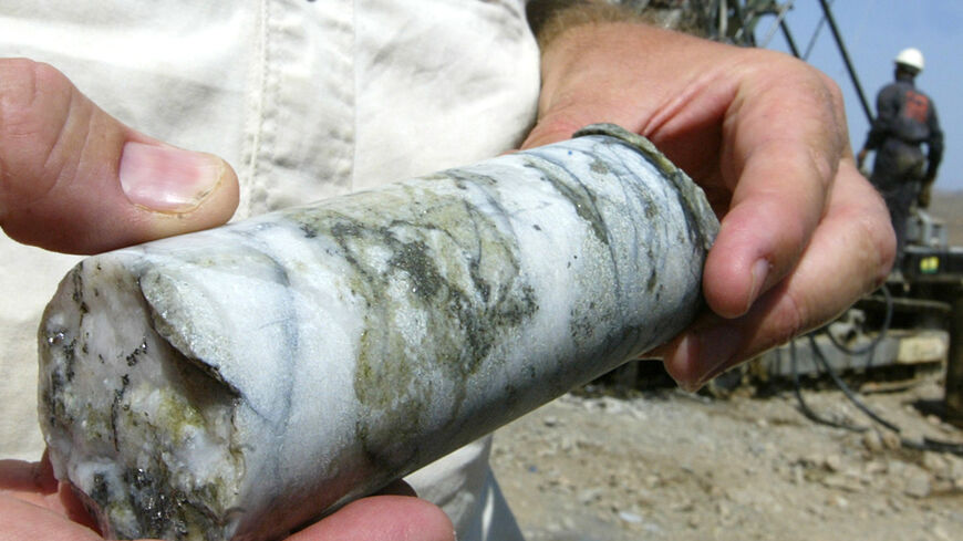 An Egyptian worker holds a mineral sample from the gold mine at Marsa Alam, in the Red Sea hills, Sept. 14, 2006. 