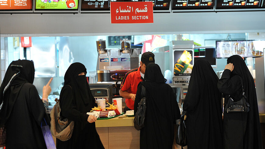 Saudi women wait in line in the "women's section" of a fast food restaurant in Faysalia mall, Riyadh City, Saudi Arabia, Sept. 26, 2011.