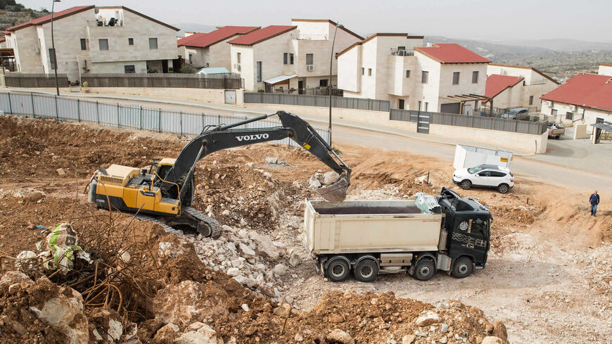 Palestinian laborers work at the construction site of a new housing project in the Israeli settlement of Ariel near Nablus, the West Bank, Jan. 25, 2017.