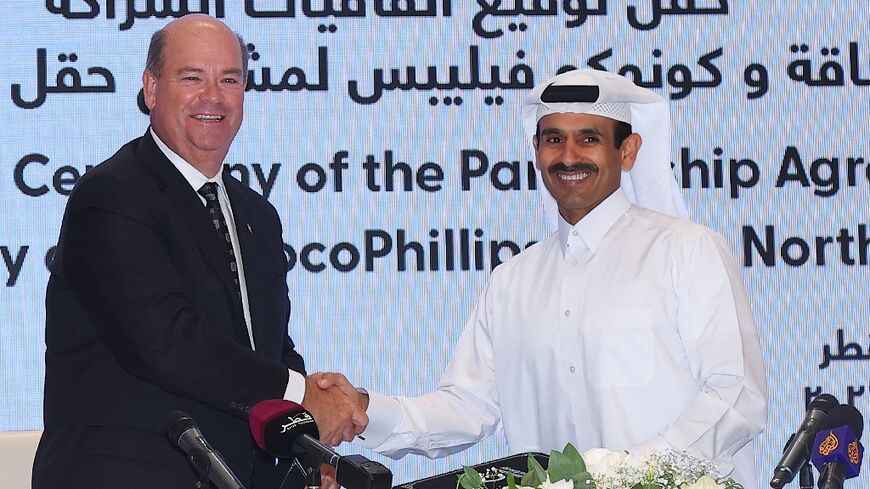 Qatar's Energy Minister and CEO of QatarEnergy Saad Sherida al-Kaabi (R) and Ryan Lance, CEO of American multinational corporation ConocoPhillips, attend a signing ceremony in Doha