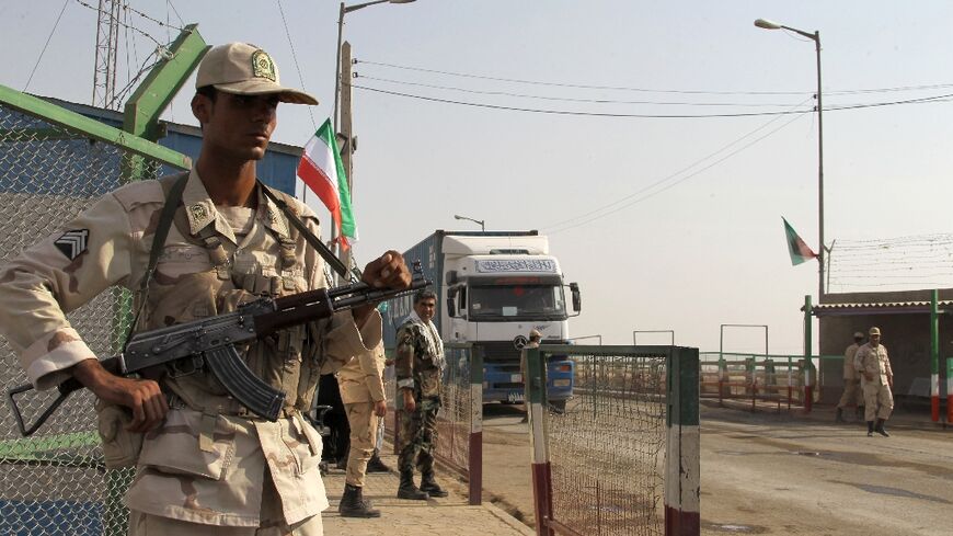 In this file photo taken on October 10, 2012 Iranian soldiers keep watch at a drug trafficking patrol post in Milak, southeastern Iran, near the Afghan border