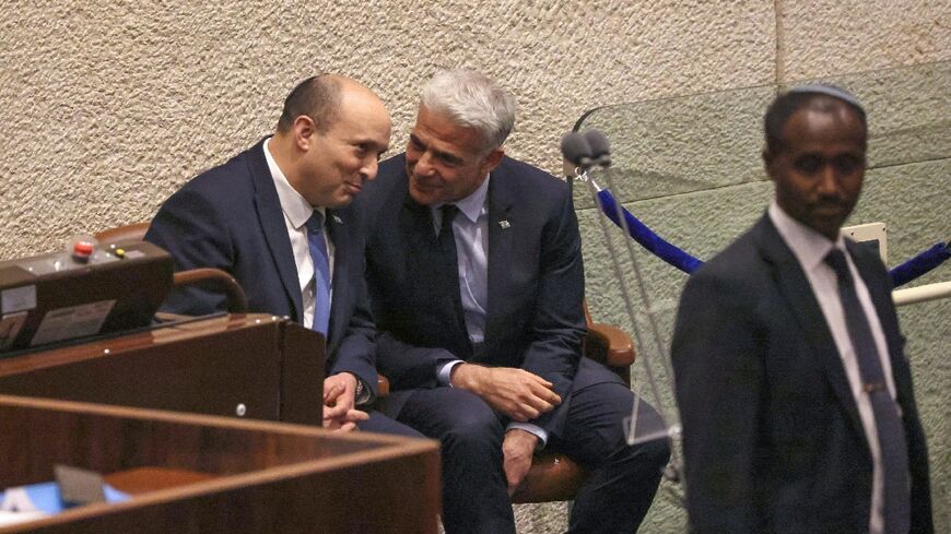 Israeli Prime Minister Nafatali Bennett and Foreign Minister Yair Lapid speak in parliament