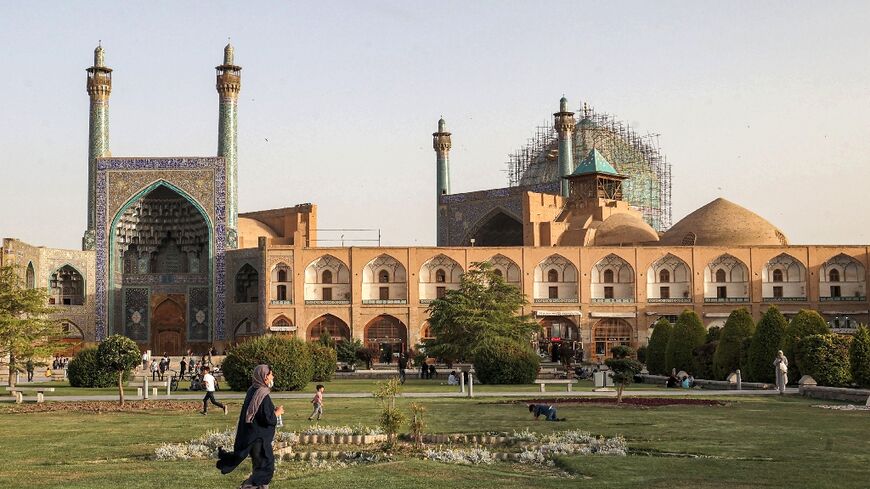 A woman walks in the garden at the historic Naqsh-e Jahan Square in Iran's central city of Isfahan in this May 2022 photograph