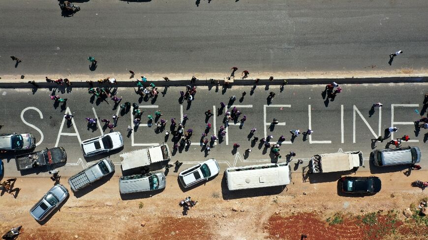 A human chain calling the continued passage of aid into Syria's rebel-held northwestern province of Idlib, seen here in this photograph from July 2, 2021