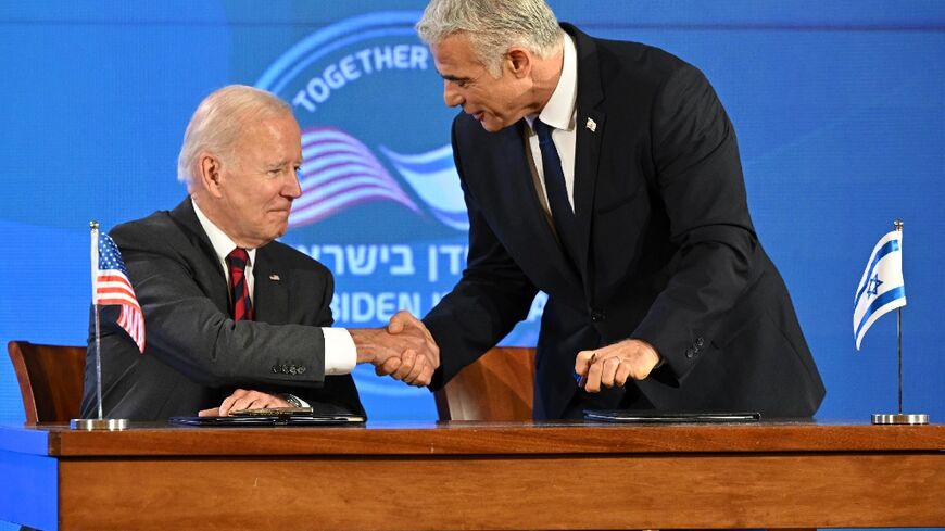 US President Joe Biden and Israel's caretaker Prime Minister Yair Lapid shake hands before signing a security pledge in Jerusalem