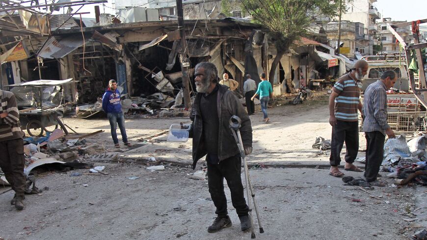 A Syrian man whose shop was destroyed in a regime aerial bombardment the previous day walks around the area on May 15, 2019.