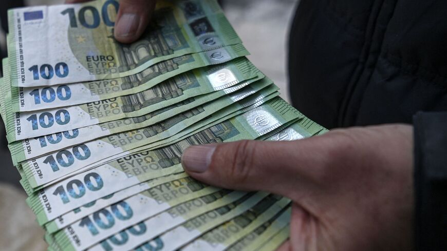 A currency exchange vendor shows a sheaf of Euro currency notes at Tahtakale in Istanbul, on March 22, 2021.