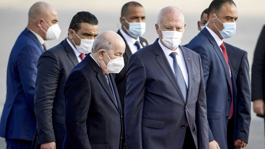 Tunisia's President Kais Saied (C-R) receives Algeria's President Abdelmajid Tebboune (C-L) as the latter arrives at Tunis-Carthage International Airport, Tunis, Tunisia, Dec. 15, 2021.