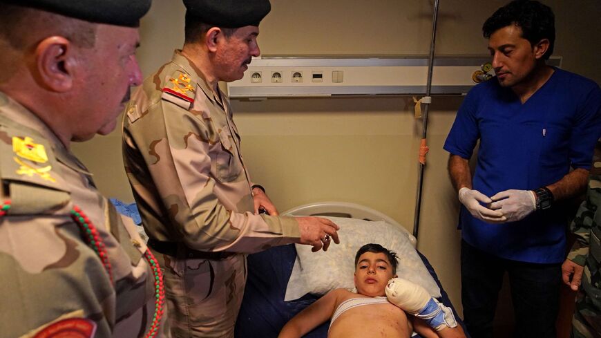 Gen. Mohammed al-Bayati, secretary of the Iraqi prime minister, visits those injured by Turkish shelling at a hospital in the city of Zakho.