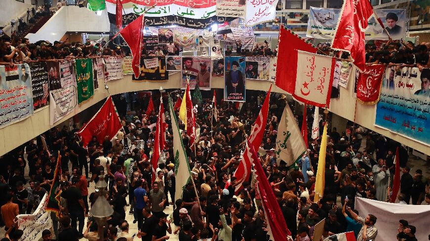 Supporters of Iraqi cleric Moqtada Sadr protest Tuesday against a rival bloc's nomination for prime minister inside parliament in the capital Baghdad's high-security Green Zone