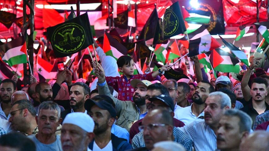 Supporters of the Islamic Jihad group rally in Yarmuk refugee camp on the outskirts of the Syrian capital Damascus to pay tribute to their fighters killed in the last round of fighting between Israel and Gaza Strip militants