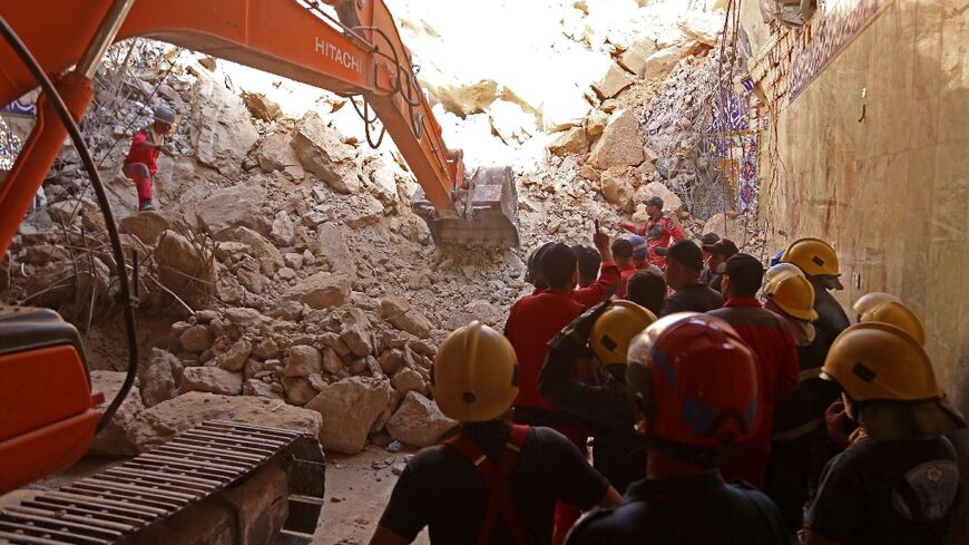 Rescuers used a backhoe and bulldozer to search the rubble for victims at Qattarat al-Imam Ali shrine in Karbala, Iraq