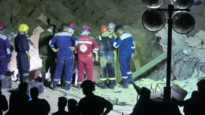 Iraqi emergency services search the rubble for survivors after a landslide hit the Qattarat al-Imam Ali shrine on the outskirts of the holy city of Karbala