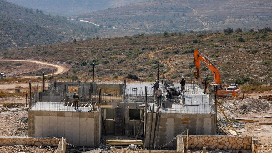 Palestinian laborers work at a construction site in the Israeli settlement of Kerem Reim, West Bank, July 31, 2019.