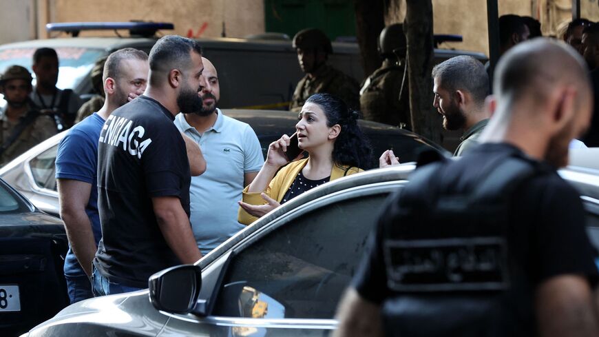 A bank employee leaves the Federal Bank of Lebanon after being held hostage.