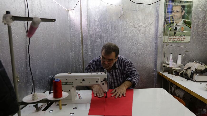 Syrian laborers work at a clothing workshop in Damascus on Feb. 2, 2016. 