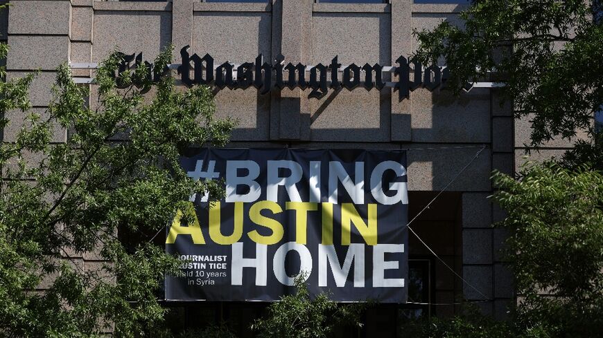 A banner reading "Bring Austin Home" hangs outside the headquarters of The Washington Post to mark the 10th anniversary of his abduction