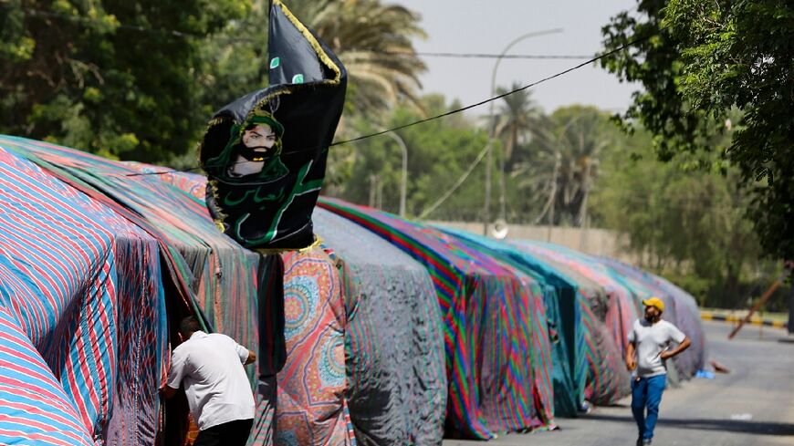 Supporters of Iraq's pro-Iran Coordination Framework gather near tents set up on a bridge leading to the capital Baghdad's Green Zone