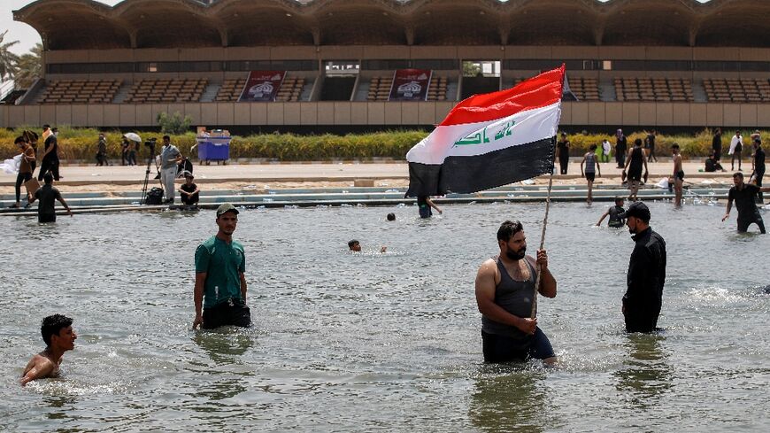 Supporters of Iraqi cleric Moqtada Sadr cool off in Baghdad's Green Zone, where they continue to protest a rival Shiite faction's nomination for prime minister