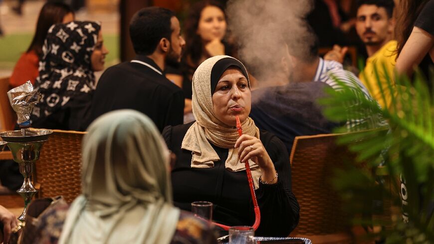 Palestinian women sit at a beach coffee shop in Gaza: but with unemployment rates hitting 47 percent last year, such outings are an unaffordable luxury for many