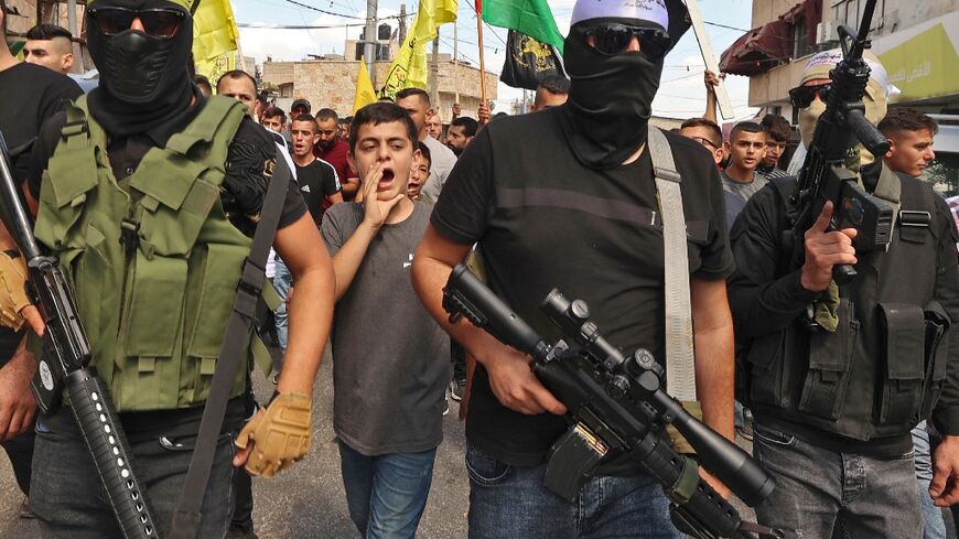 Palestinians march in the village of Kafr Dan, to show solidarity with the families of two Palestinians killed in overnight clashes with Israeli security forces