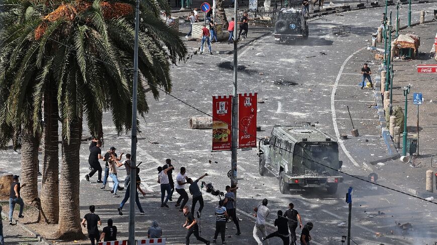 Young Palestinians engage in running battles with police in Nablus on Tuesday turning the heart of the West Bank city into a combat zone