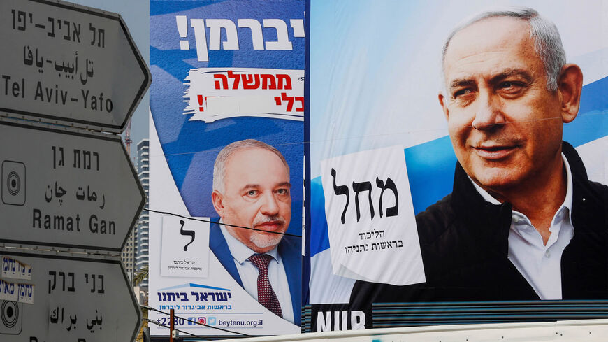 This photo shows election campaign posters of (L to R) Israel's Yisrael Beitenu party bearing a portrait of its leader Avigdor Liberman and the Likud party showing its leader and incumbent Prime Minister Benjamin Netanyahu, Bnei Brak, Israel, March 14, 2021.