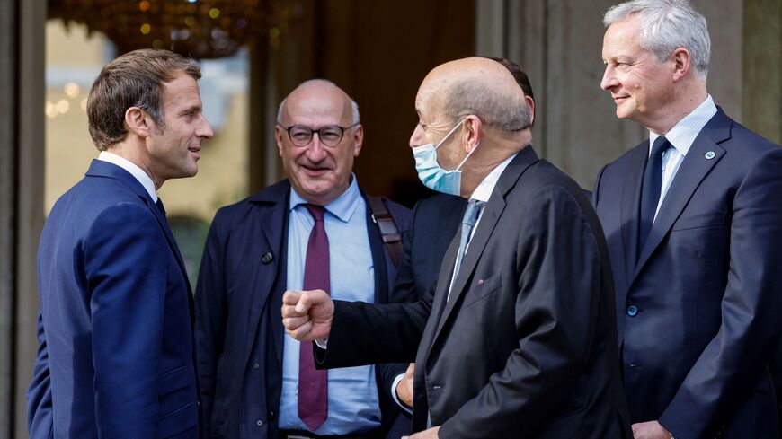 (from L) French President Emmanuel Macron (L), France's ambassador to the USA Philippe Etienne, French Foreign Minister Jean-Yves Le Drian and French Economy Minister Bruno Le Maire arrive at the French Embassy to the Vatican in Rome on October 29, 2021 ahead of a meeting with US President. (Photo by Ludovic MARIN / AFP) (Photo by LUDOVIC MARIN/AFP via Getty Images)