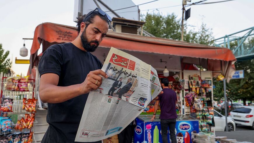 A man reads the Iranian newspaper Etemad, with the front page title reading in Farsi "The night of the end of the JCPOA ", and cover photos of Iran's Foreign Minister Hossein Amir-Abdollahian and his deputy and chief nuclear negotiator Ali Bagheri Kani, in the capital Tehran on Aug. 16, 2022.