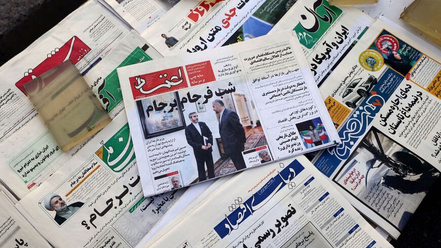 A picture shows a newspaper stall with a view of Etemad newspaper's front page bearing a title reading in Farsi "The night of the end of the JCPOA ", and cover photos of Iran's Foreign Minister Hossein Amir-Abdollahian his deputy and chief nuclear negotiator Ali Bagheri Kani, in the capital Tehran on August 16, 2022. 