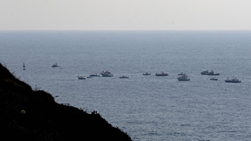 Lebanese protesters sail in boats with slogans affirming Lebanon's right to its offshore gas wealth, near a border-marking buoy between Israel and Lebanon in the Mediterranean waters off the southern town of Naqoura, Sept. 4, 2022.