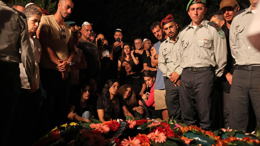 Mother (C) of slain Israeli Maj. Bar Falah, killed overnight during operational activity adjacent to the Gilboa crossing, mourns during his funeral, Netanya, Israel, Sept. 14, 2022.