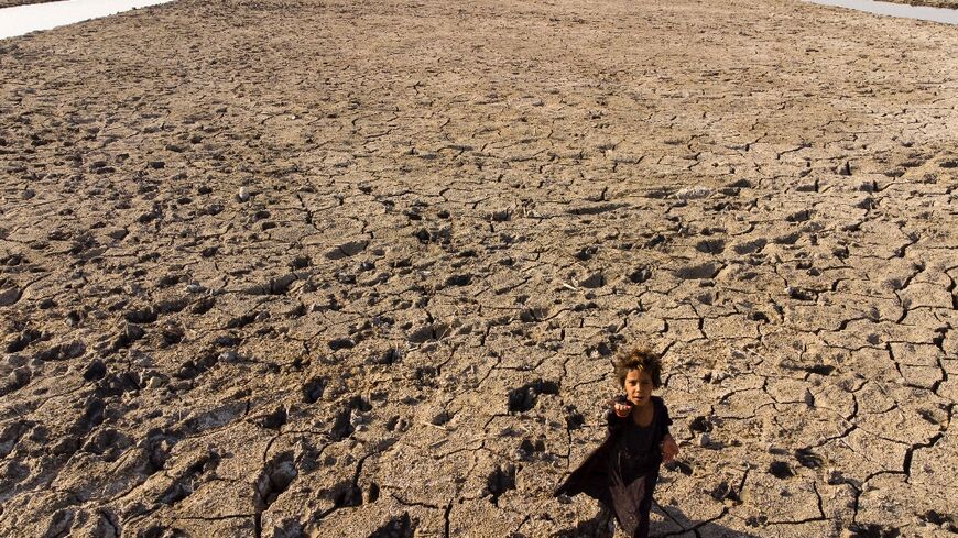 Heatwaves, drought and sandstorms have hit Iraq, one of the countries most threatened by climate change. A child walks though dried marshes in southern Dhi Qar province on August 23, 2022