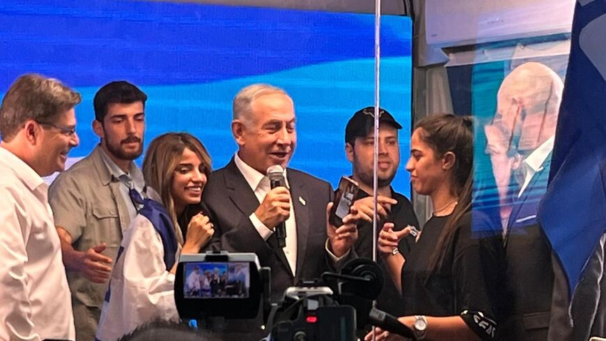 Netanyahu campaigns behind glass