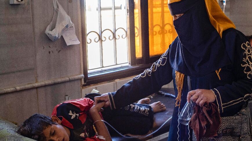 A child suffering from cholera receives treatment at the Al-Kasrah hospital in Syria's eastern province of Deir Ezzor on September 17