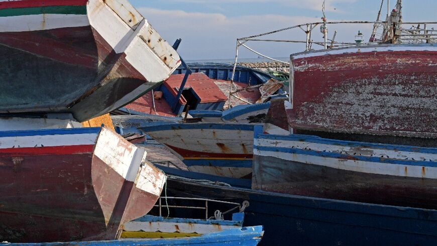 Piles of captured migrant boats are seen in the central Tunisian port city of Sfax on October 4