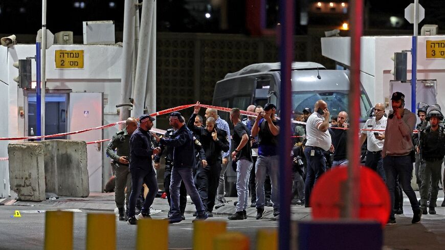 Israeli police and forensic experts gather following a shooting attack at a checkpoint near the Shuafat Palestinian refugee camp in Israeli-annexed east Jerusalem