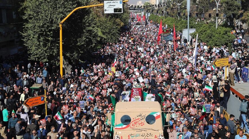 Mourners take part in a funeral for victims of a mass shooting at a key shrine earlier in the week that killed more than a dozen worshippers, in Iran's southern city of Shiraz, on October 29, 2022