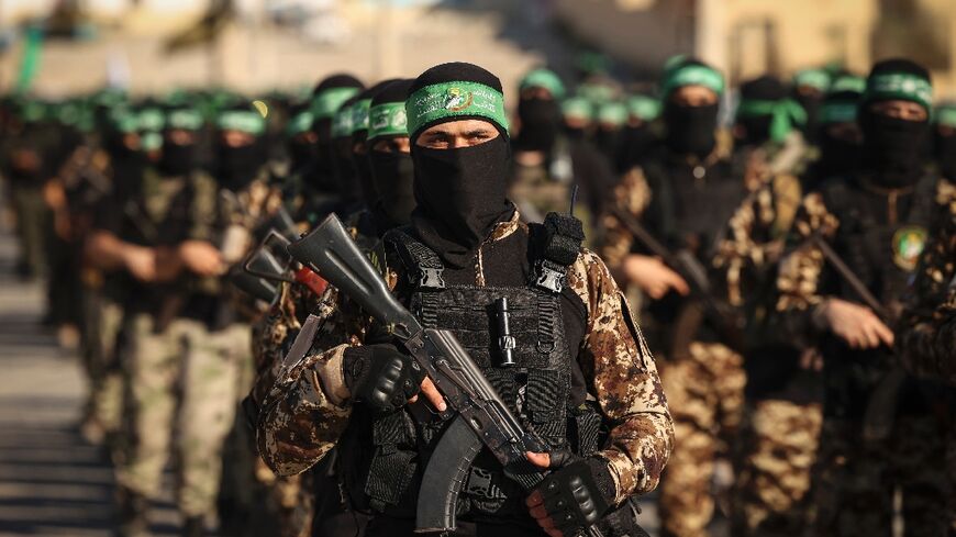 Masked members of the al-Qassam Brigades, the military wing of Hamas, march during a rally in Gaza City on July 20, 2022