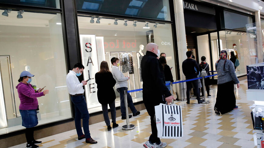 People walk past the Zara store in a shopping mall, Modiin, Israel, Feb. 21, 2021.