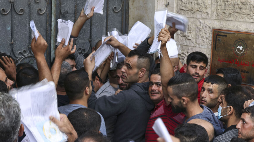 Palestinian men gather to apply for work permits in Israel.