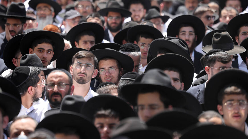 Thousands of ultra-Orthodox Jews attend the funeral of Rabbi Shalom Cohen, influential spiritual leader of Israel's largest ultra-Orthodox Shas party, Jerusalem, Aug. 22, 2022.